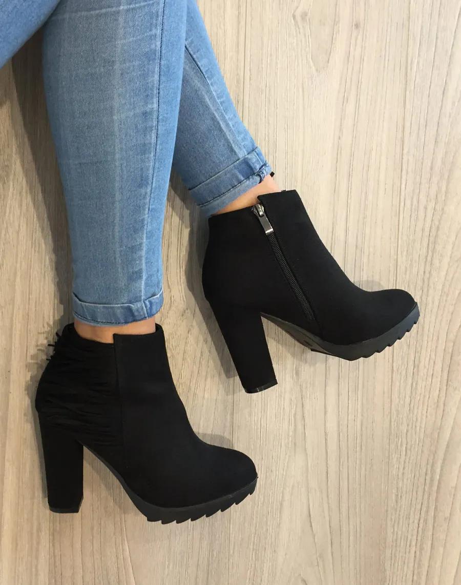 Black suede fringe ankle boots.