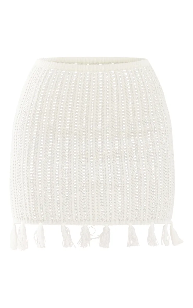 Low waisted cream crochet knit mini skirt with fringe.