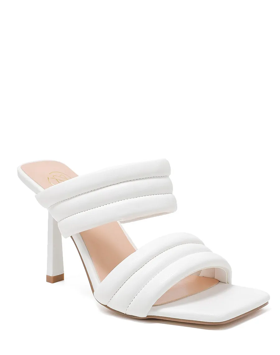 White sandals with thick straps and stiletto heel.