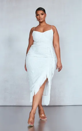 White draped knee-length dress with underwire and fringe.