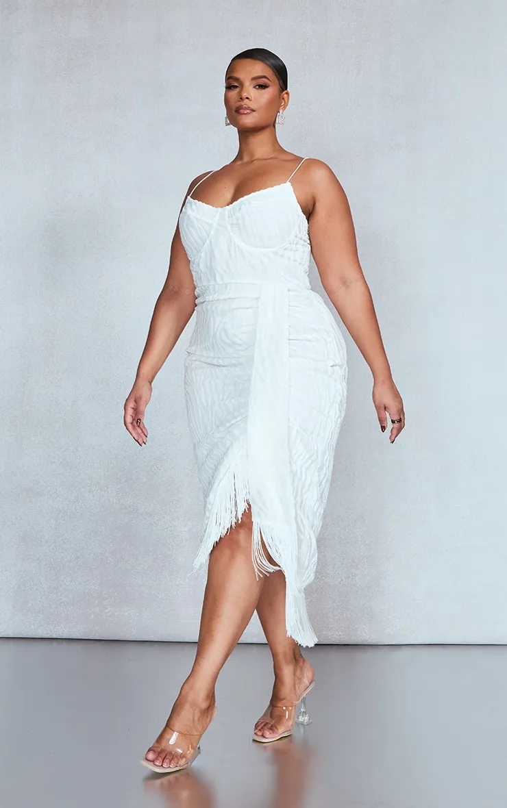 White draped knee-length dress with underwire and fringe.