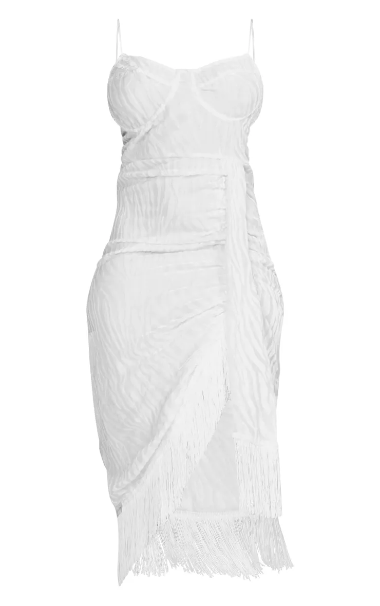 White draped knee-length dress with underwire and fringe.